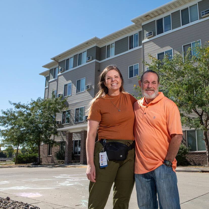 Christopher Doss smiling with a Sanford employee.