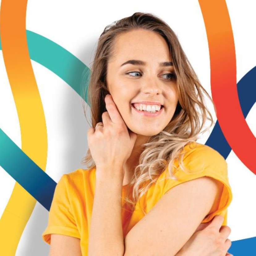 Woman posing in front of a background.