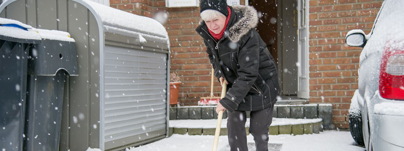 Senior shoveling snow.